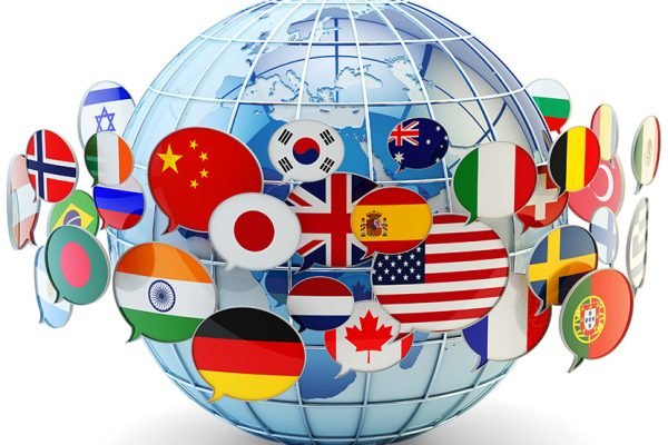 Speech bubbles with national flags of world countries around blue Earth globe isolated on white background.